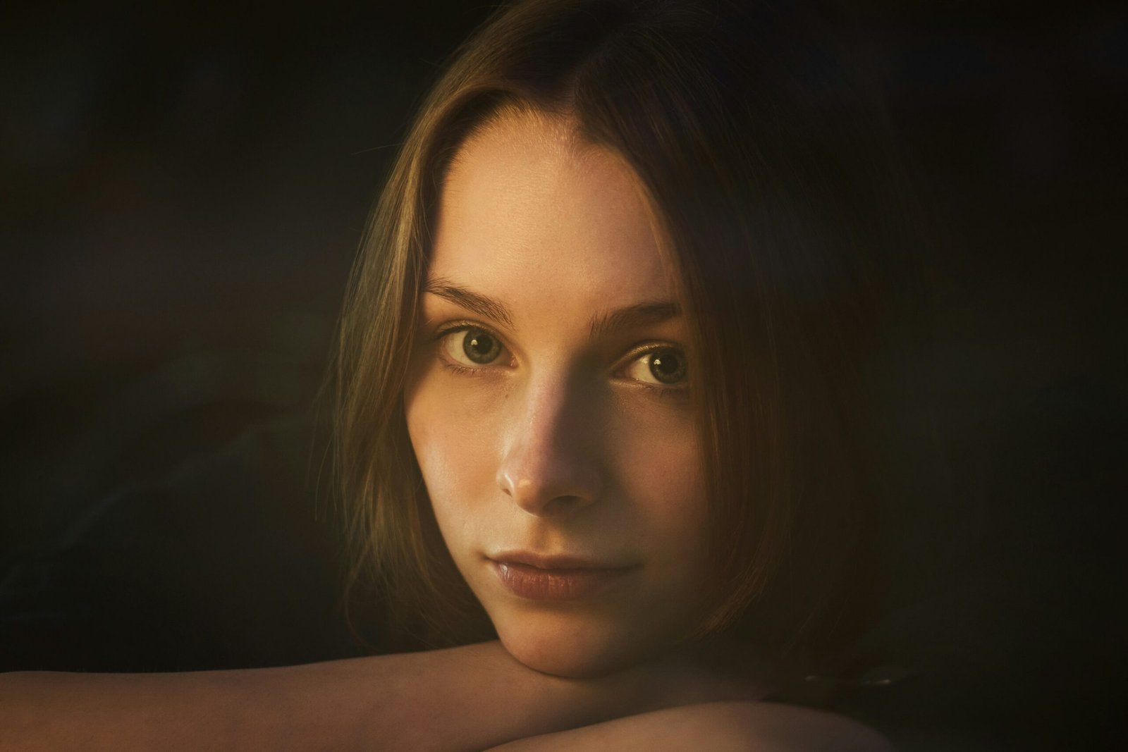 woman with brown hair looking up